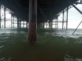 waves incoming green ocean salt water close up under pier side Royalty Free Stock Photo