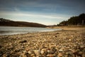 Beach by the frozen lake. Beautiful sunny winter day. Royalty Free Stock Photo