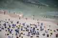 Beach full of people having fun swimming and sunburning Royalty Free Stock Photo
