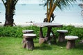 beach garden with wooden table and chairs - gardening and landscaping