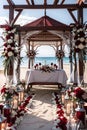 Beach gazebo wedding: red and white floral arrangements, planned to perfection. Exterior view. Royalty Free Stock Photo