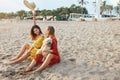 Beach. Girls With Dog On Sandy Coast. Fashion Women In Bohemian Clothing And Straw Hat With Pet