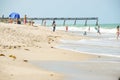 Beach Goers near Ocean Pier Royalty Free Stock Photo