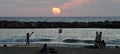 Beach goers silouhetted at sunset in Tel Aviv, Israel