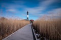 Beach grass blowing in the wind, with wispy clouds across the sky. Fire Island Lighthouse - Long Island NY Royalty Free Stock Photo