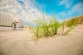 Beach grass and Beach cabins on white sand on the sand dunes in the wind.Beach summer background.Summer mood. Royalty Free Stock Photo