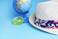 Beach hat on a blue background. Defocused globe, toy. Tourist vacation during the coronavirus pandemic. Copy space - travel Royalty Free Stock Photo