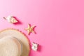 Beach hat with seashells on pink wooden table. summer background concept with copy space top view Royalty Free Stock Photo