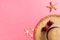 Beach hat with seashells on pink wooden table. summer background concept with copy space top view Royalty Free Stock Photo