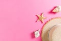 Beach hat with seashells on pink wooden table. summer background concept with copy space top view Royalty Free Stock Photo