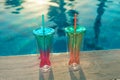 Beach holidays background with two cocktails In mermaid tail glass near swimming pool in luxurious hotel Royalty Free Stock Photo