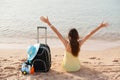 Beach holidays woman enjoying summer sun sitting in sand looking happy at copy space. Beautiful young model Royalty Free Stock Photo