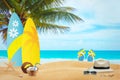 The beach in the hot summer time. In the background is sufr board and slippers Royalty Free Stock Photo