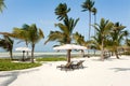 Beautiful beach with palm trees sun lounger parasols of Hotel Baraza Resort Zanzibar