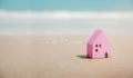 Beach House Concept. Mini Colorful Wooden House on the Sand Beach. Destination for Vacation or Retirement Life. Summer Sunny Day