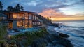 A beach house with large windows overlooking the ocean at sunset Royalty Free Stock Photo