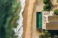 Beach house with pool on oceanfront, top view.