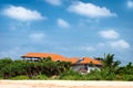 Beach house with solar panels and tropical forest