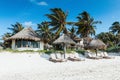 Beach houses and palms on the shores of the Caribbean Sea in Tulum, Mexico.