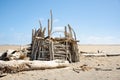 Beach hut made of sticks and driftwood on a sunny day in New Zealand Royalty Free Stock Photo