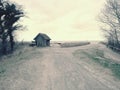 Beach hut at sand dunes, end of road next sea. Old wooden house for fishers. Royalty Free Stock Photo