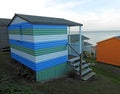 Beach huts chalets sheds in a row by the coast