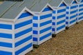 Blue and white beach huts on the beach at Hastings, Eangland UK