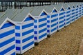 Blue and white beach huts on the beach at Hastings, Eangland UK