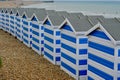 Blue and white beach huts on the beach at Hastings, Eangland UK