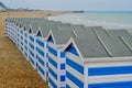 Brightly coloured beach huts on the beach at Hastings, Eangland UK