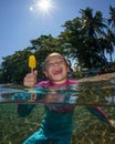 Sea, ice cream and portrait of a happy laughing child on the beach in the water against the background of blue sky and Royalty Free Stock Photo