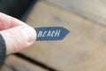 Beach idea. A hand holds a pointer with the inscription beach Royalty Free Stock Photo