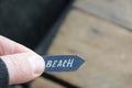 Beach idea. A hand holds a pointer with the inscription beach. Royalty Free Stock Photo