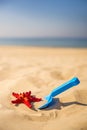 Beach with kid toys shovel, bucket and red sea star Royalty Free Stock Photo