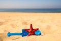 Beach with kid toys shovel, bucket and red sea star Royalty Free Stock Photo