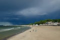 Beach in Kolobrzeg and dramatic heavy clouds in the sky Royalty Free Stock Photo