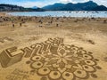 Beach of La Concha in San Sebastian, Spain. Sand graffiti Royalty Free Stock Photo