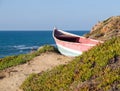 Beach landscape - Skiff boat on the cliff Royalty Free Stock Photo