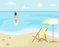 Beach landscape with sun lounger and sun umbrella. Girl in a swimsuit is in the sea