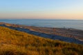 Beach landscape reclaimed land in Netherlands by sunset mood