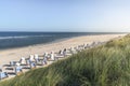 Beach landscape on Sylt island. High grass, sand, chairs and sea Royalty Free Stock Photo