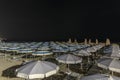 Beach and lido at night with umbrellas and deck chairs Royalty Free Stock Photo