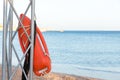 Beach life-saving. lifeguard tower with orange buoy on the beach. rescue buoy on the iron rescue post Royalty Free Stock Photo