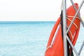 Beach life-saving. lifeguard tower with orange buoy on the beach. rescue buoy on the iron rescue post Royalty Free Stock Photo