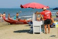 Beach lifeguard surrounded by resting people in Viareggio, Italy Royalty Free Stock Photo