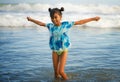 Beach lifestyle portrait of young beautiful and happy Asian child girl 8 or 9 years old with cute double buns hair style playing Royalty Free Stock Photo