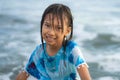 Beach lifestyle portrait of young beautiful and happy 7 or 8 years old Asian American mixed child girl with wet hair enjoying Royalty Free Stock Photo