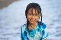 Beach lifestyle portrait of young beautiful and happy 7 or 8 years old Asian American mixed child girl with wet hair enjoying Royalty Free Stock Photo