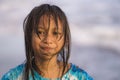 Beach lifestyle portrait of young beautiful and happy 7 or 8 years old Asian American mixed child girl with wet hair enjoying Royalty Free Stock Photo