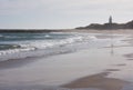 A beach and a lighthouse in the distance at Waipapa Point in the Catlins in the South Island in New Zealand